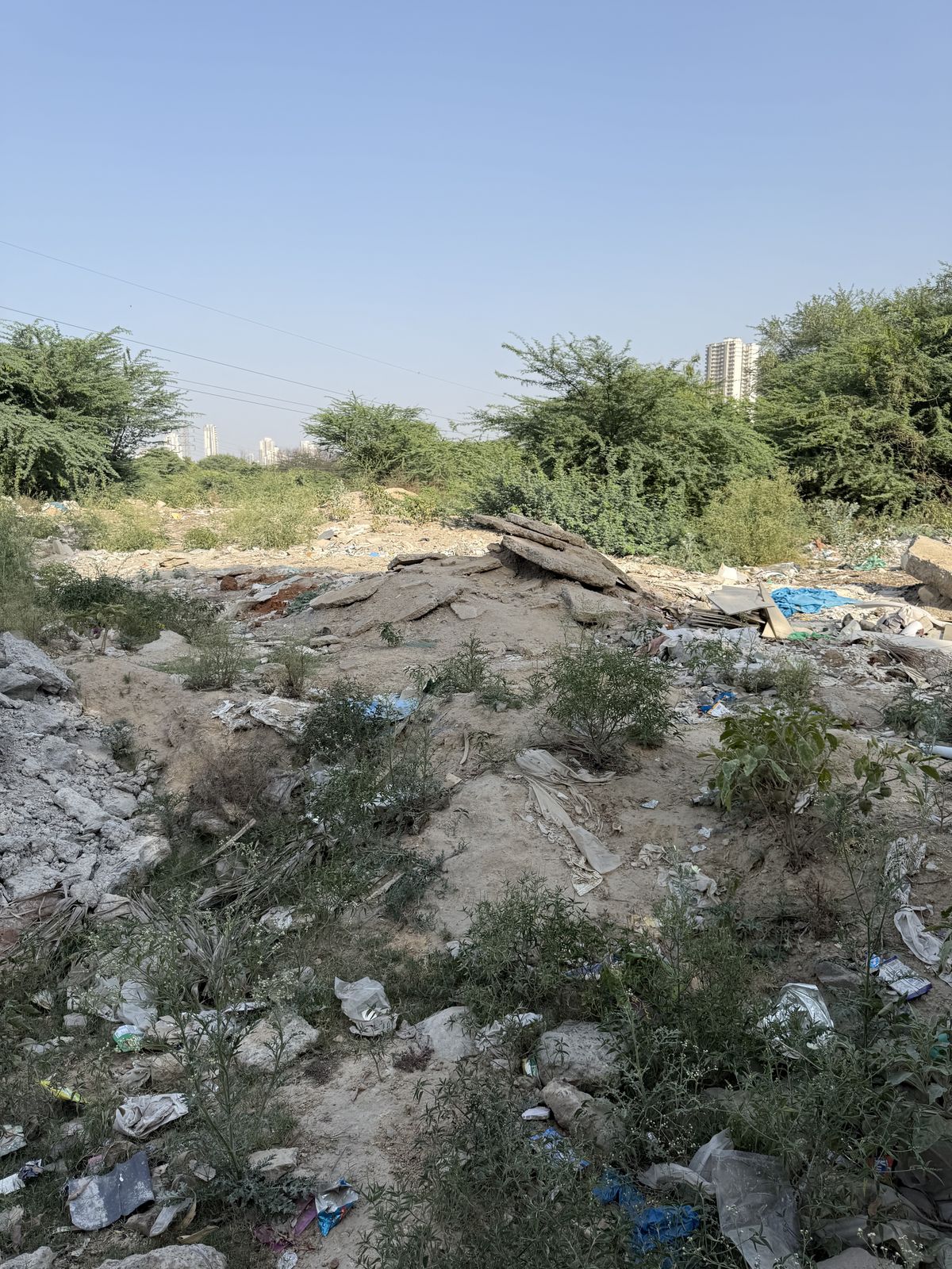 Rubble, plastic and household waste over dry ground