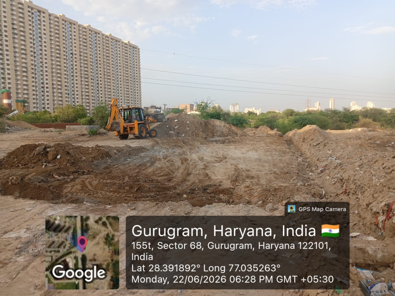 A backhoe loader on levelled ground in evening light